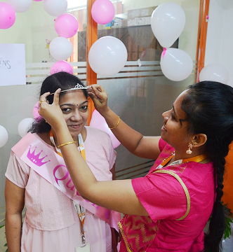 Team member being crowned during Women's Day celebration